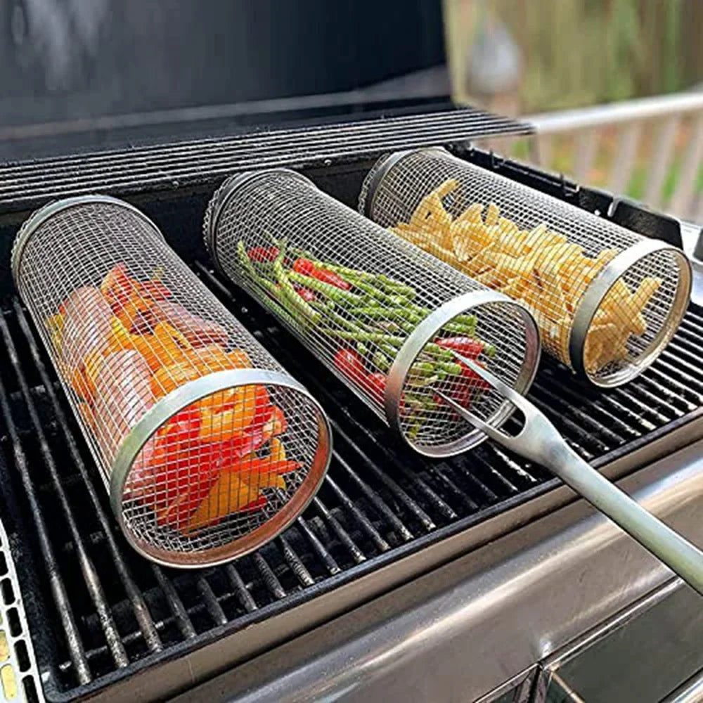 Stainless steel BBQ grill baskets with vegetables and fries on outdoor barbecue